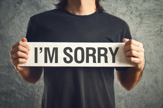 showing a sign saying sorry